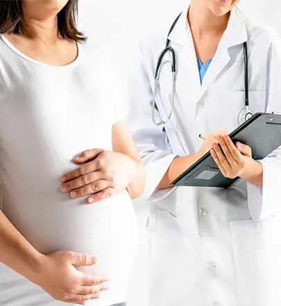 Pregnant Woman speaking to Gynecologist regarding her maternity